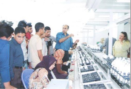 Students training at an energy-saving lamp factory, 2008